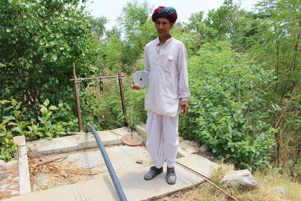 One of the Bhujal Jankaars measuring groundwater levels manually. Credit: B. Mesashwari