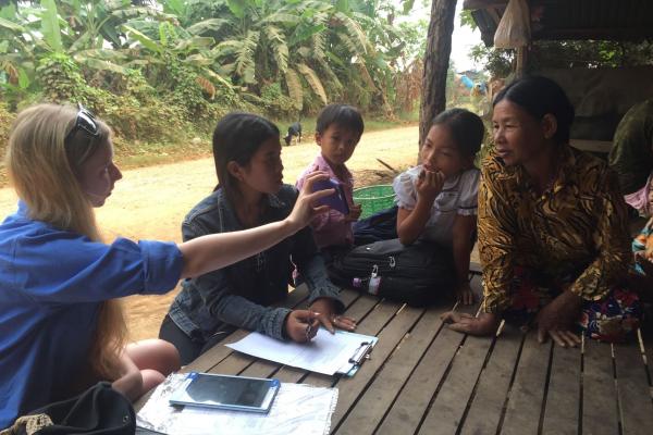 Isabel Sinclair-Hinchcliffe and Sophea Yous demonstrating the mungbean Pest ID App to a farmer in Angsang Sak village. Photographer: Bob Martin