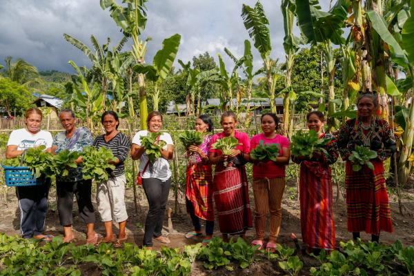  Women show the vegetables they harvest from their community garden in Paraiso village in Koronadal City in the Southern Philippine Province of South Cotabato, Mindanao