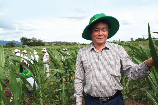 man standing in crop field
