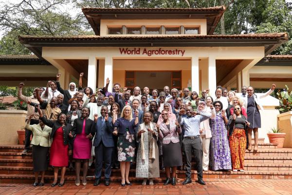 Group photo of participants in front of a building