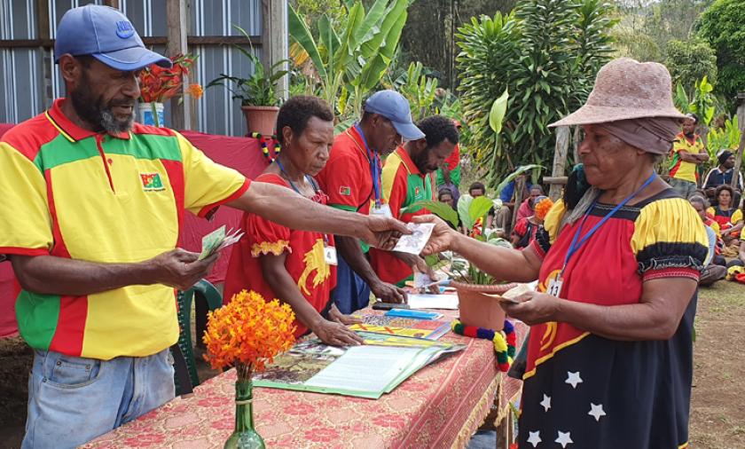 Farmers from Bena in Eastern Highlands of Papua New Guinea receive payments for the sale of the first batch of high quality coffee, thanks to new technology and farming practices provided through the ACIAR supported project. Photo supplied by CIC Socio Economist and Project Coordinator, Dr Reuben Sengere