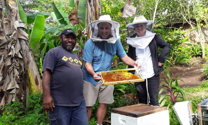 (L-R) Head of Helping hands Honey production Kelly Inae, showing Chris Cannizzaro and Professor Helen Wallace pollen frames from his hives in Goroka. Research has just been concluded on the composition of bee diets in PNG that will provide useful information for improved honey production. Photo supplied by Chris Cannizzaro.