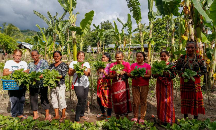  Women show the vegetables they harvest from their community garden in Paraiso village in Koronadal City in the Southern Philippine Province of South Cotabato, Mindanao