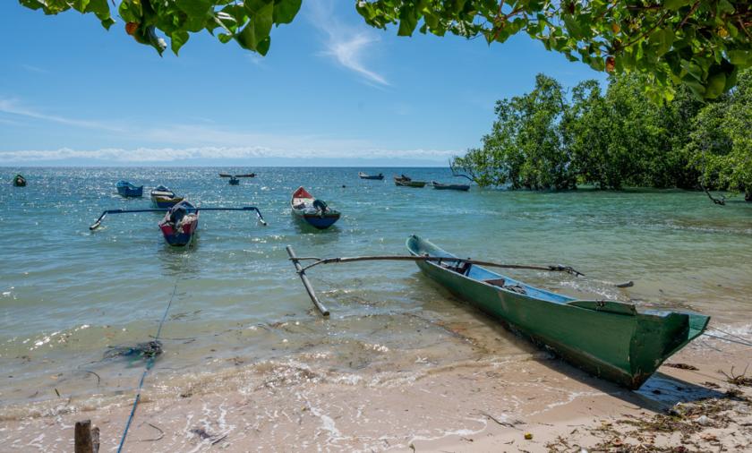 Fishing boats in a clear way bay on a sunny day with blue skies